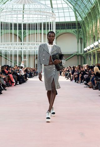 A model walking in the spring summer 2025 Chanel show at the Grand Palais during Paris Fashion Week.