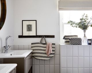 A white bathroom with a floating shelf