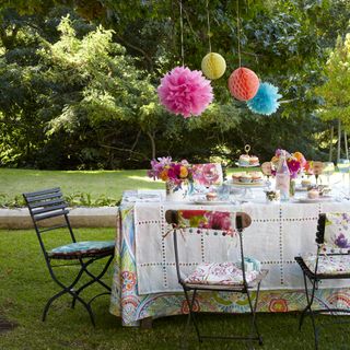 garden with table and paper pompom decoration