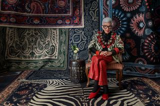 Iris Apfel sitting on her Ruggable collection