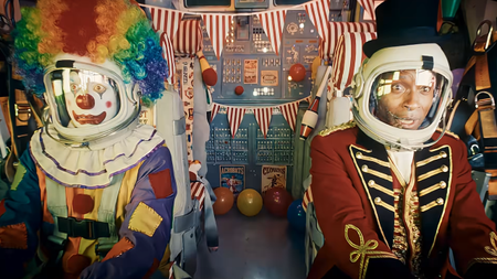 A clown and circus ringmaster astronauts