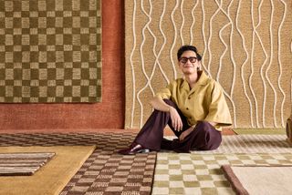 arvin olano sitting on his geometric rug collection