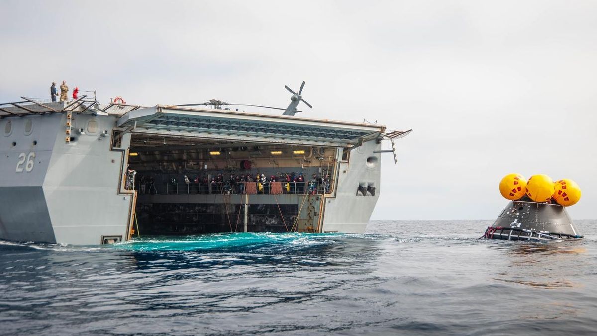 A simulated Artemis 2 spacecraft, known as the Orion Crew Module Test Article, approaches the U.S.S. John P. Murtha warship during practice recovery operations on July 27, 2023.