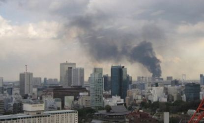 Smoke rises from buildings in Japan after the earthquake hit Friday.