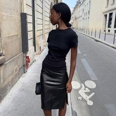 sylvie mus wearing a pencil skirt and t shirt