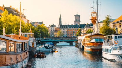 Moored boats along a narrow canal in Copenhagen old town, Denmark