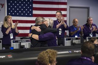 The Cassini team cheers, hugs and cries after receiving the final signal from Cassini that indicated the mission had come to an end with the spacecraft's disintegration in Saturn's atmosphere.