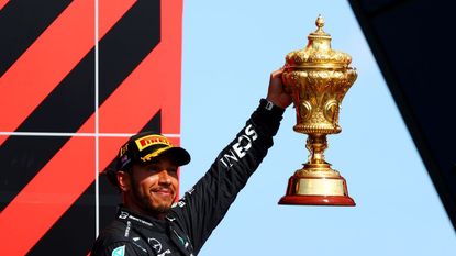 Race winner Lewis Hamilton of Great Britain and Mercedes GP celebrates on the podium after the F1 Grand Prix of Great Britain at Silverstone on July 18, 2021