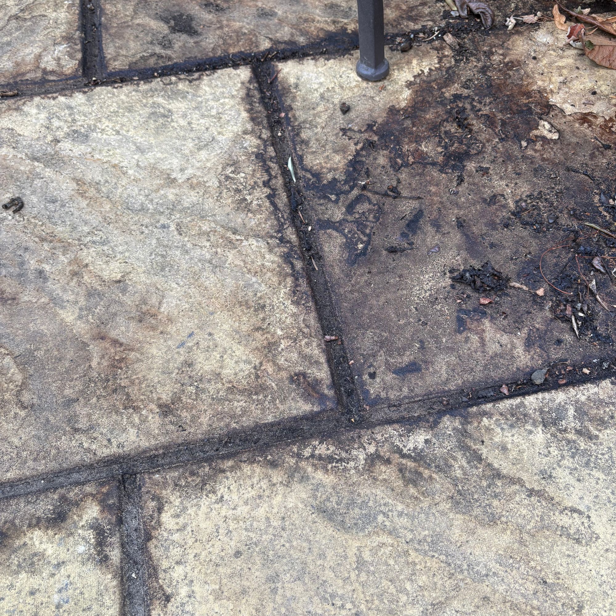Compost stains and debris on a garden patio