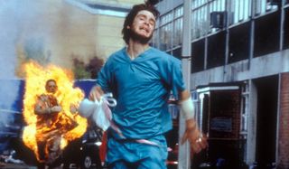 Cillian Murphy runs from a burning Infected in 28 Days Later.
