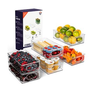 Six storage bins with fruit and vegetables in, next to a box