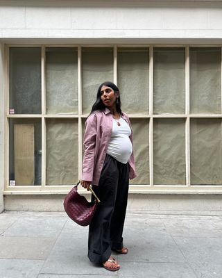 @monikh wearing a woven red leather back with shirt and trousers