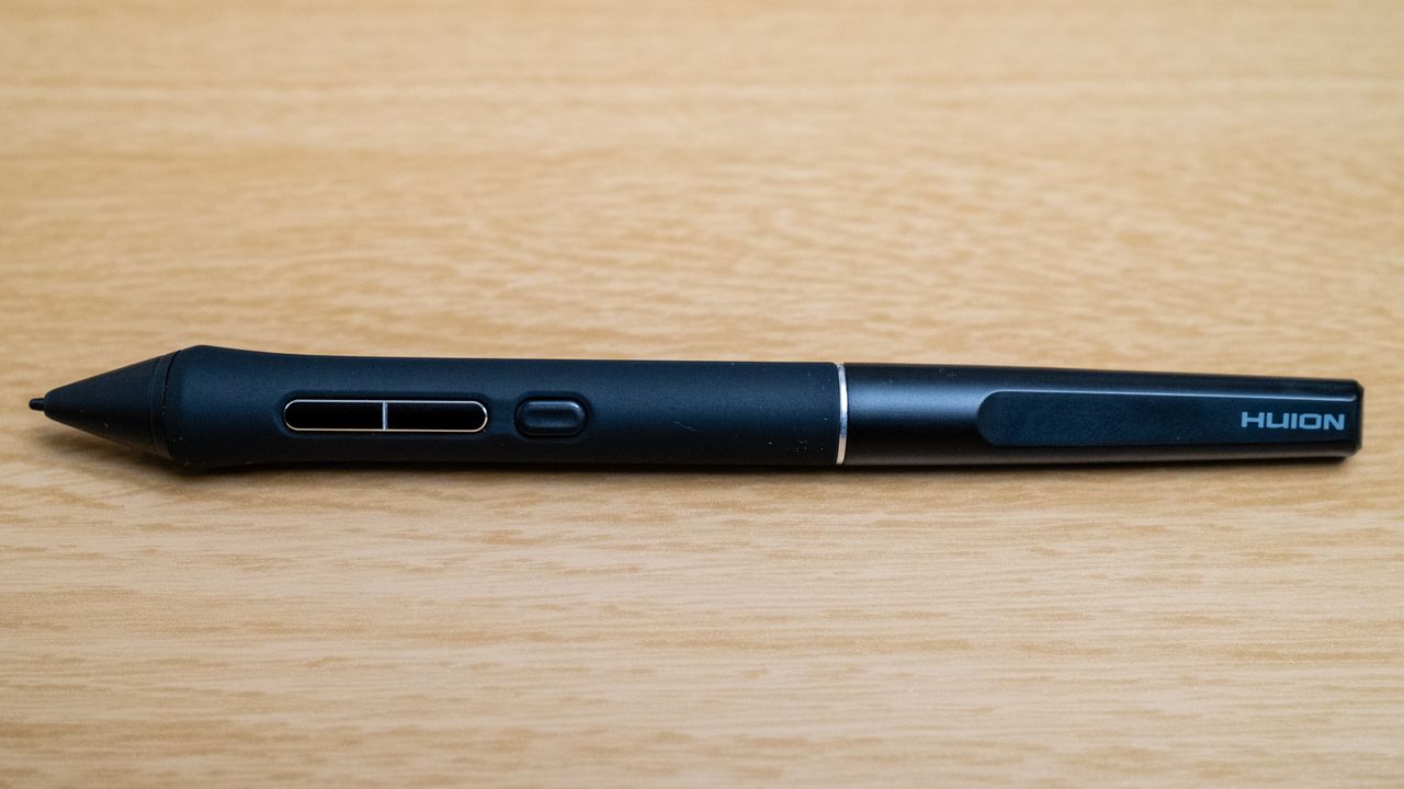 The pen for a Huion Kamvas 16 (Gen 3) drawing tablet on a wooden desk