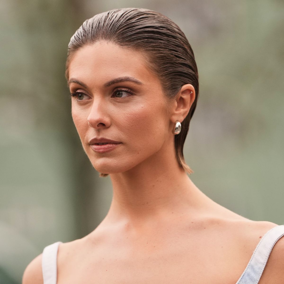 woman with slicked back hair and bronzed skin