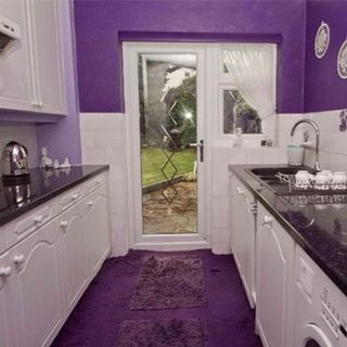 kitchen room with purple wall and cabinets with glass door