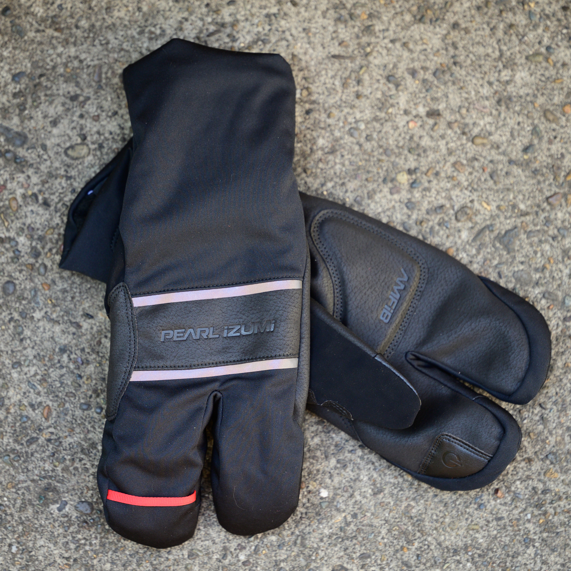 Pearl Izumi AmFib Lobster gloves on a concrete floor 