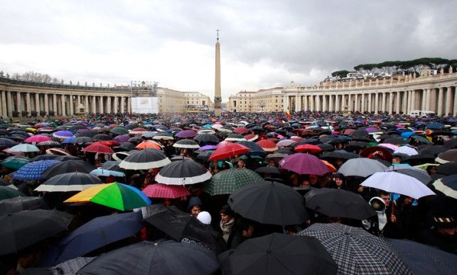 Devotees from across the globe, take shelter under umbrellas in St. Peter&amp;#039;s Square, March 13.