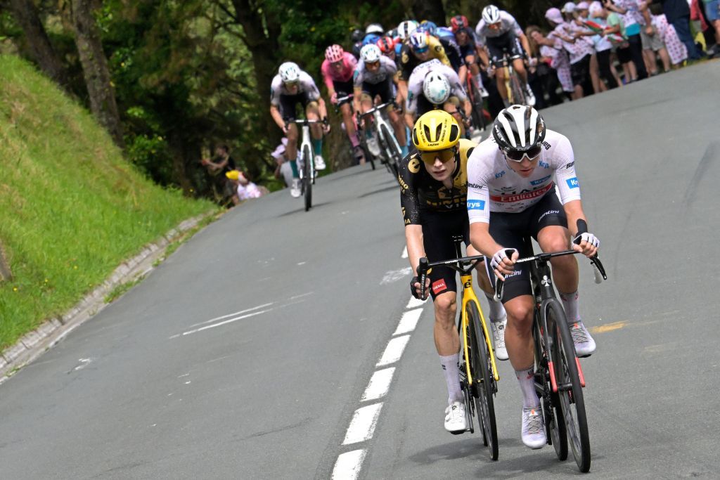JumboVismas Danish rider Jonas Vingegaard L and UAE Team Emirates Slovenian rider Tadej Pogacar wearing the best young riders white jersey R cycle on the Col Jaizkibel during the 2nd stage of the 110th edition of the Tour de France cycling race 2089 km between VitoriaGasteiz and San Sebastian in northern Spain on July 2 2023 Photo by Bernard PAPON AFP Photo by BERNARD PAPONAFP via Getty Images