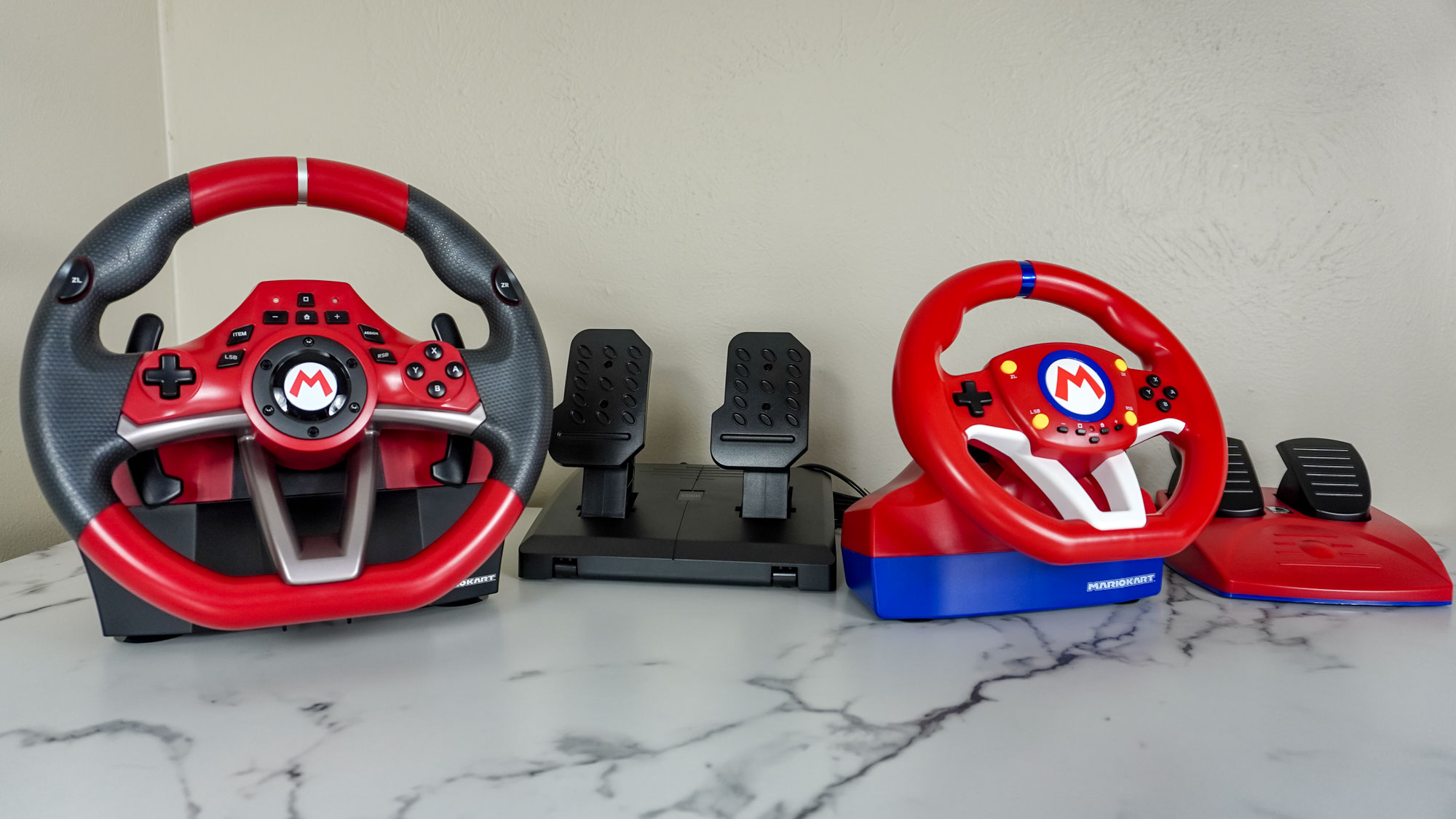 The Hori Pro Deluxe and Pro Mini racing wheels on a desk