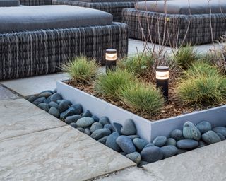 patio with rocks edging raised bed