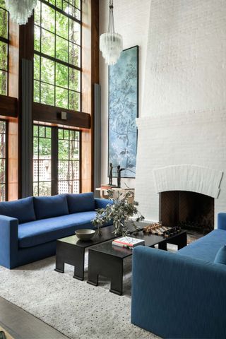 A grey rug with blue sofa
