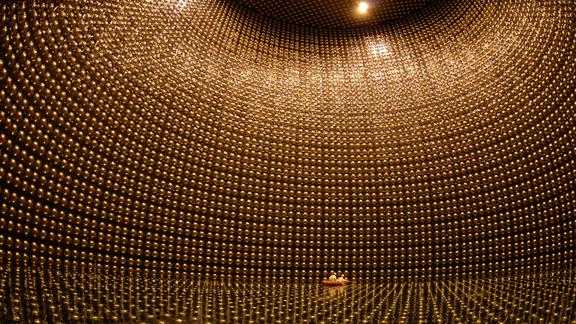 a massive underground chamber lined wall-to-wall with golden orbs