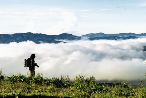 A race photographer watches the clouds.