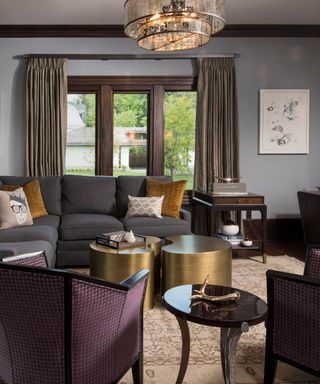 A living room with a vintage area rug and gold accents