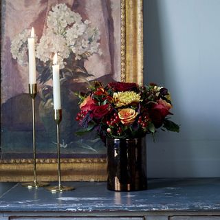 coloured flower vase with candles