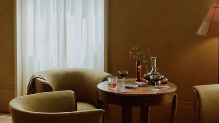 a small table with digestif glasses on, playing cards, with a retro 70s style