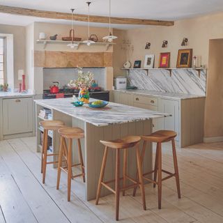 Sage green shaker kitchen with island and plastered walls
