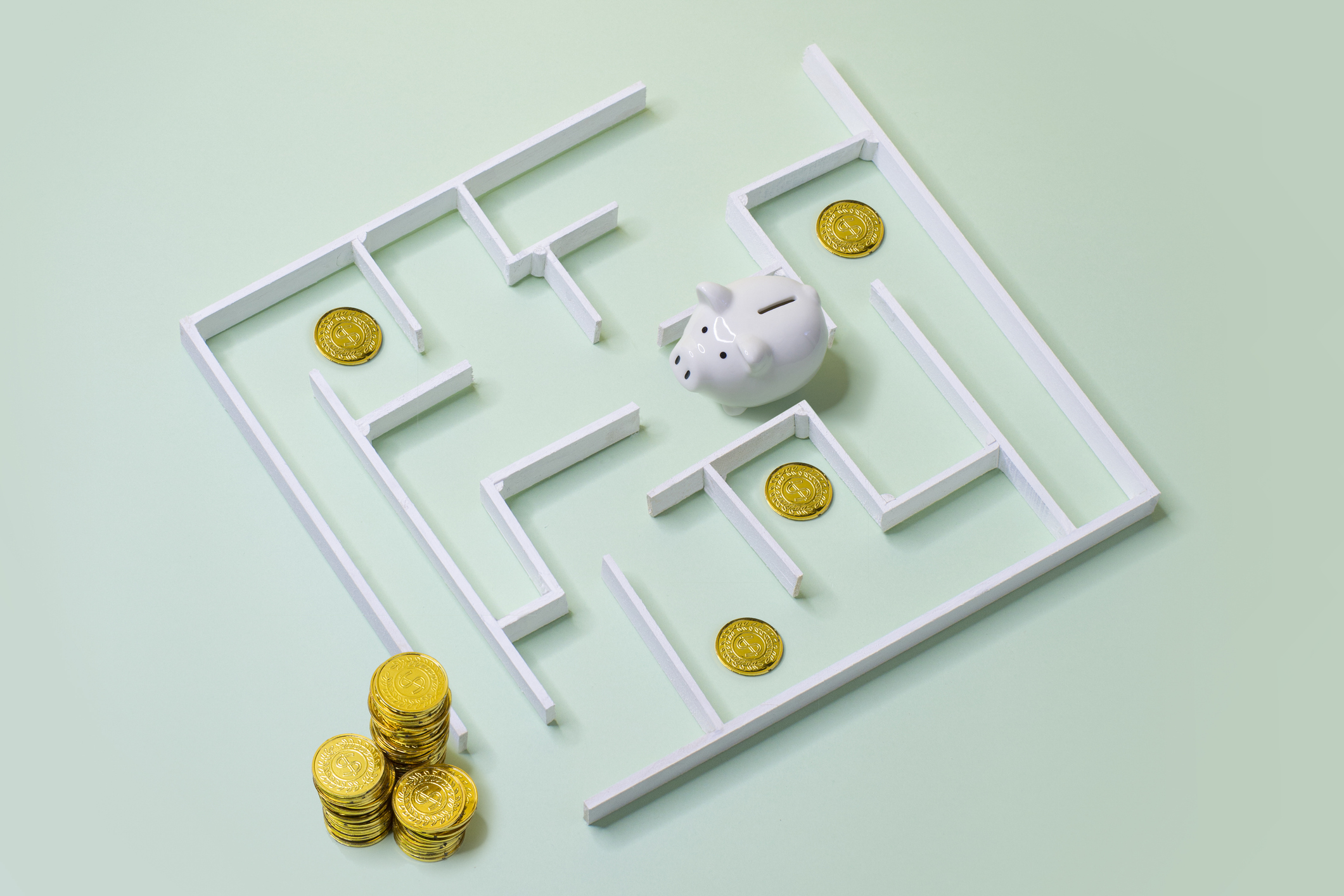Piggy bank at the centre of a maze