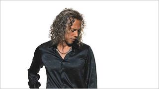 Kirk Hammett wearing a black shirt, looking at the floor 