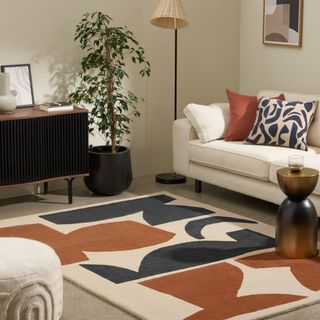 Made.com Lafant Hand-Tufted Wool Rug placed in living room with white sofa, floor lamp, plant