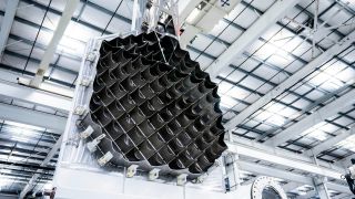 A metal lattice of spikes sits vertically mounted to a wall in a cleanroom