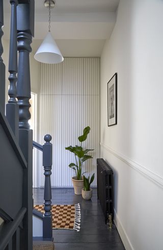 Hallway with painted black wooden flooring