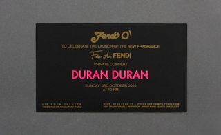 Back view of ﻿Fendi's invitation pictured against a grey background