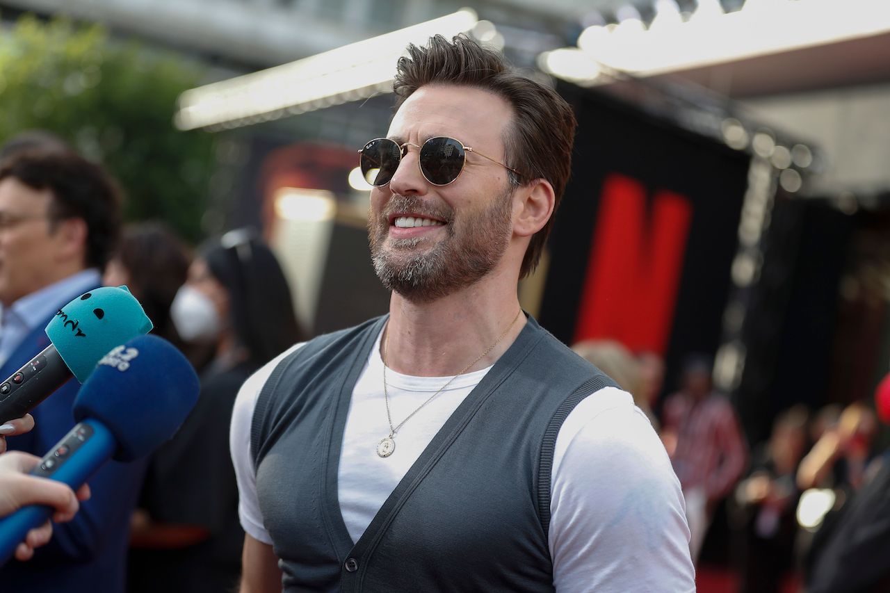 Chris Evans sonriendo en la alfombra roja de Grey Man