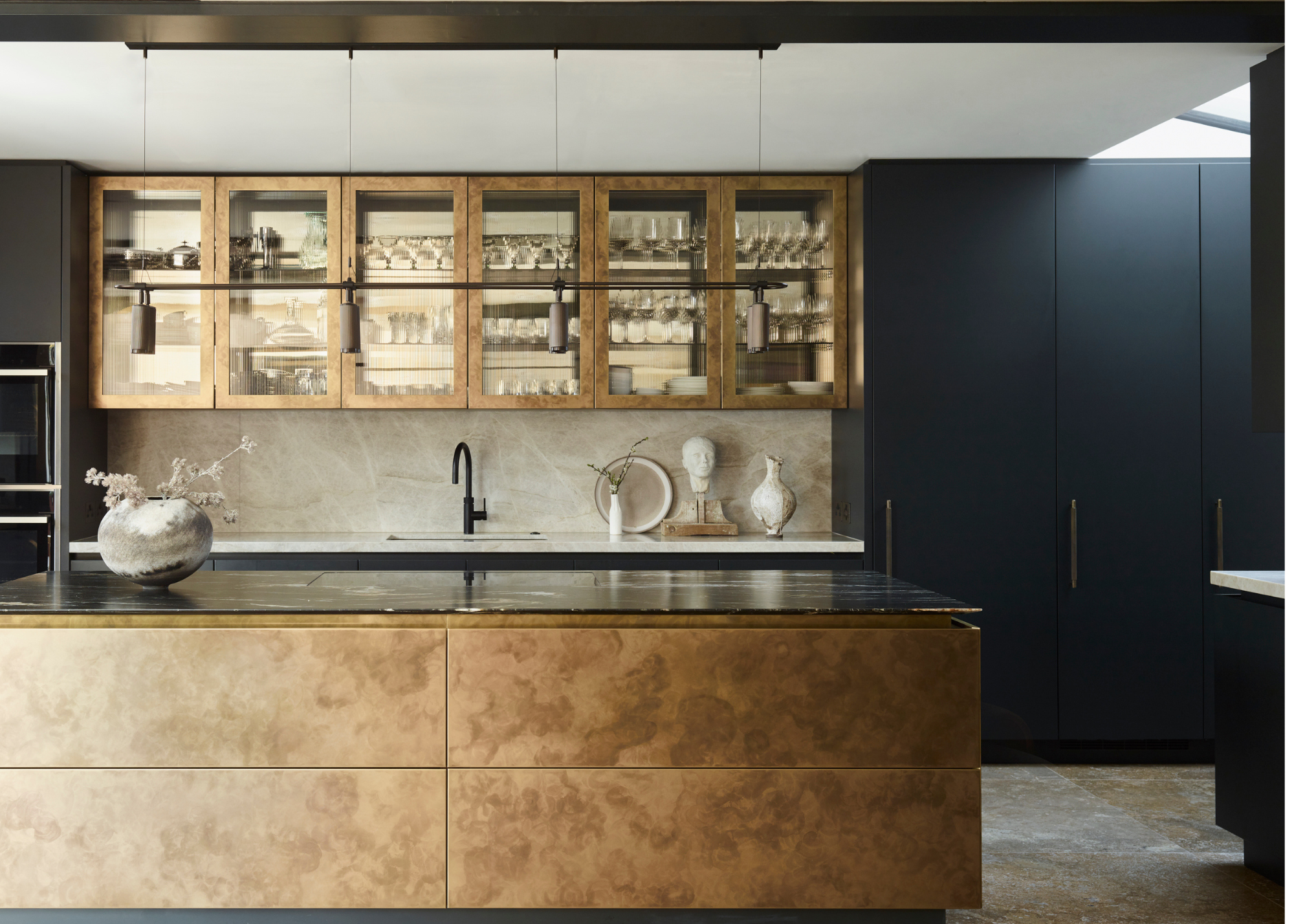 modern kitchen with rusted gold island and dark blue cabinetry