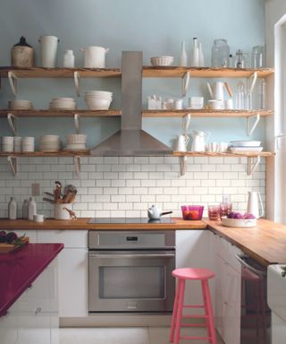 Light blue kitchen feature wall with rustic wooden open shelving