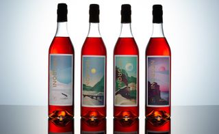 These four bottles having different landscape pictures