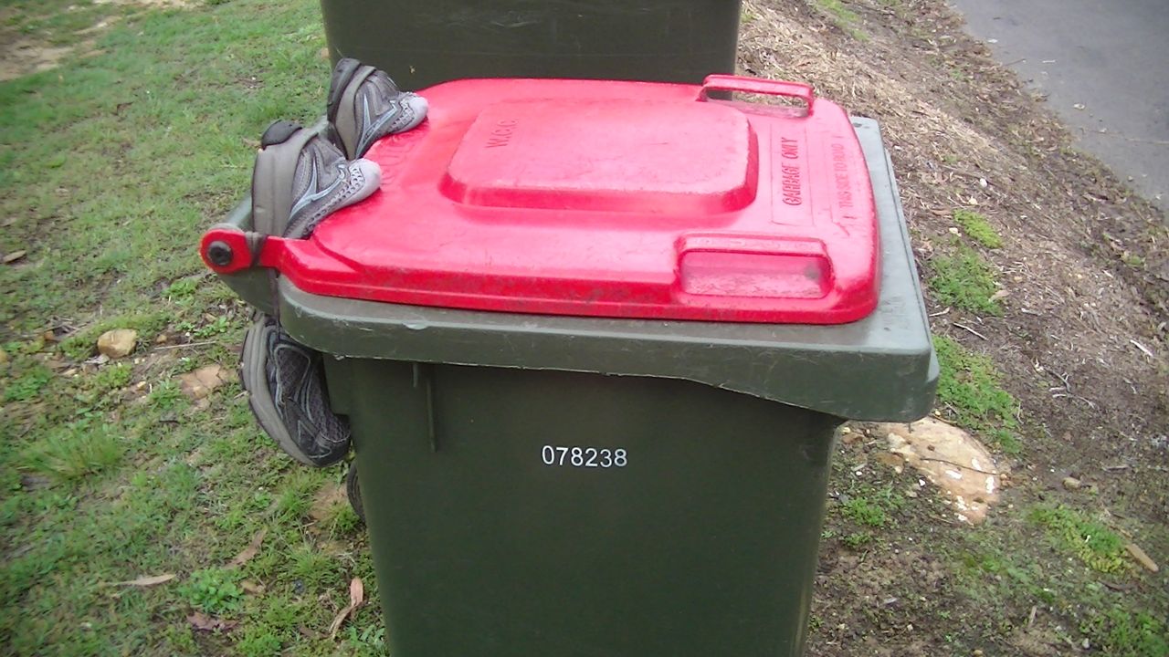 A pair of old running shoes are jammed in the hinge to stop cockatoos lifting the lid.