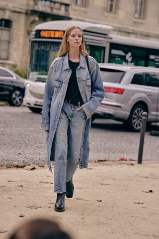 Fashion week spring/summer 2024 attendee wearing denim top and jeans