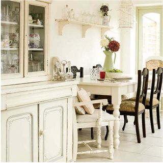 dining area with white table and crockery dresser