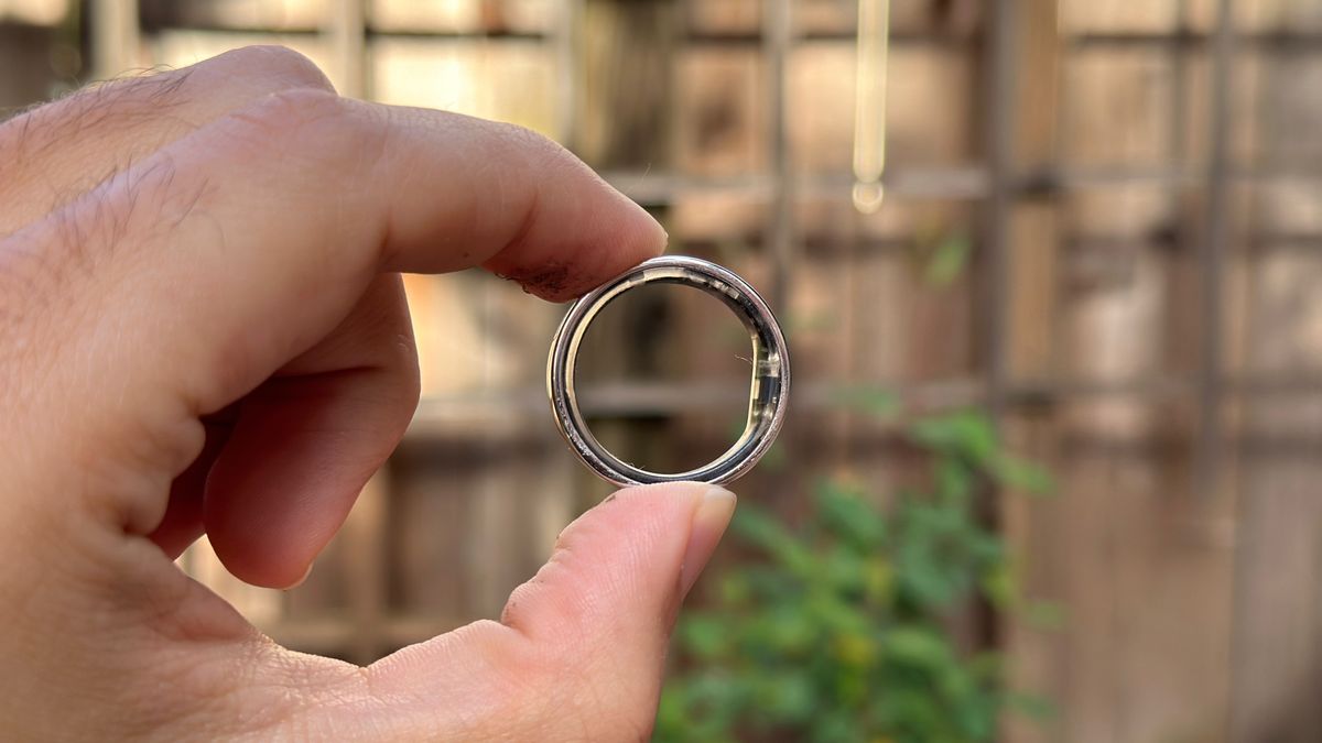 The Ultrahuman Ring Air held sideways by the author.