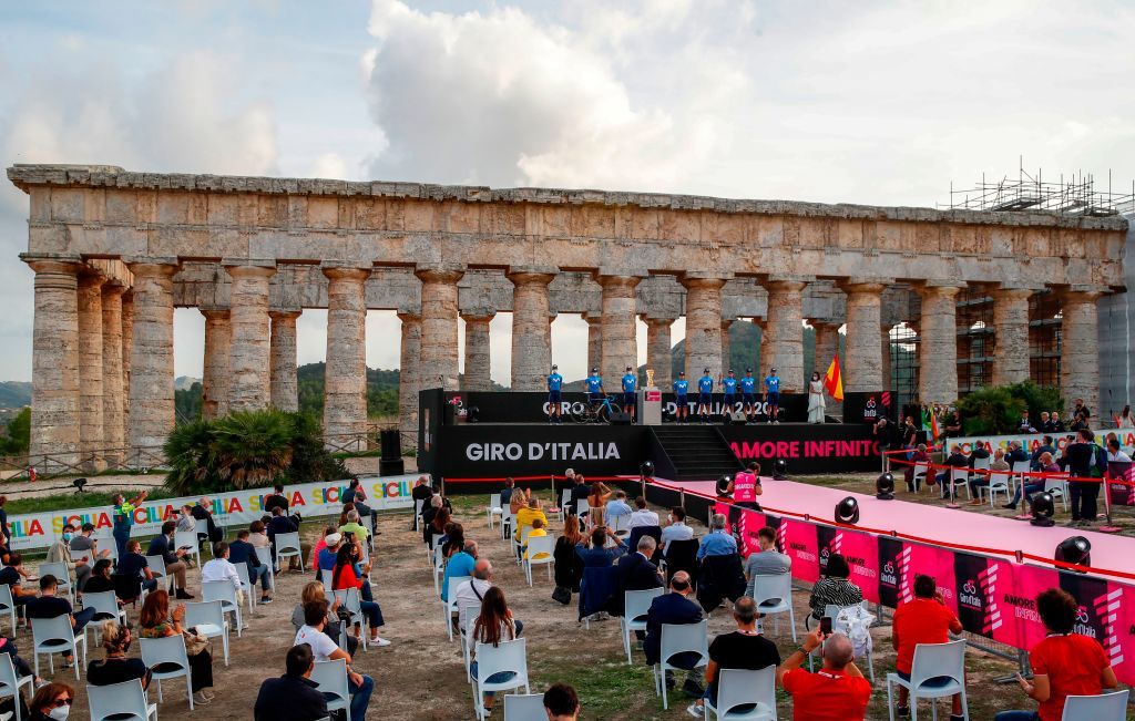 Socially distanced spectators attend the presentation of the Movistar Team Rear on stage at the Doric Temple of Segesta near Palermo Sicily on October 1 2020 during an opening ceremony of presentation of participating teams and riders two days ahead of the departure of the Giro dItalia 2020 cycling race Photo by Luca Bettini AFP Photo by LUCA BETTINIAFP via Getty Images