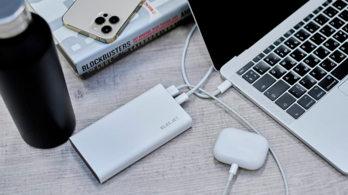 Elecjet Apollo Ultra graphene battery pack being used to charge a MacBook and AirPods Pro on a desk
