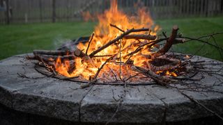 A fire pit with stacked logs