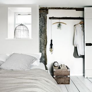 bedroom with white wall and bed and alarm watch