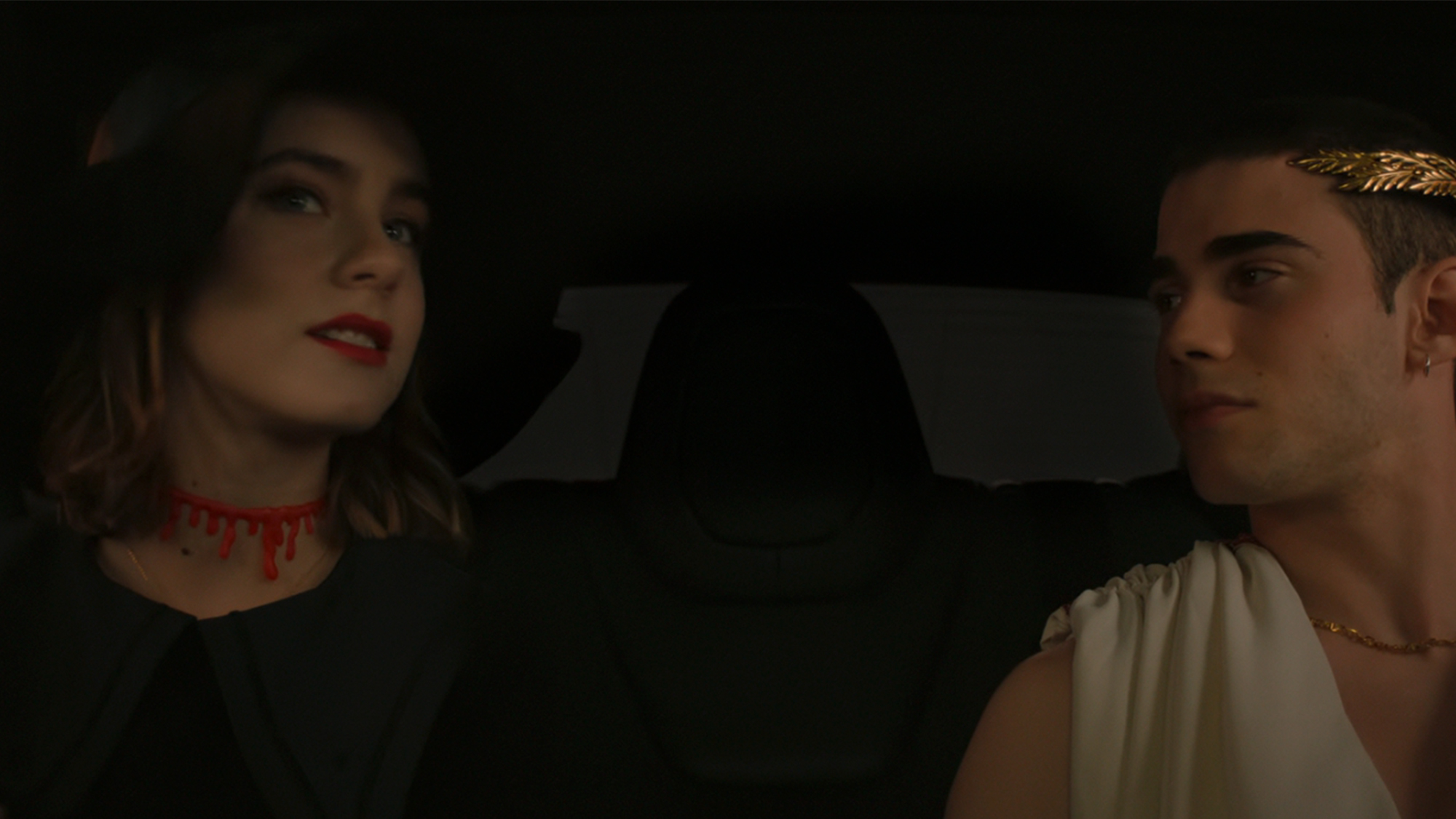 Two people in halloween costumes in a car together in Through My Window